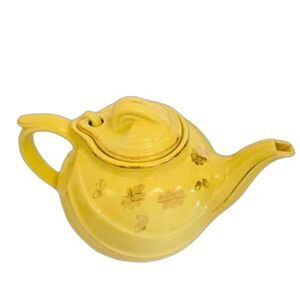 Antique yellow ceramic teapot